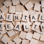 Scrabble pieces spelling "MENTAL HEALTH"