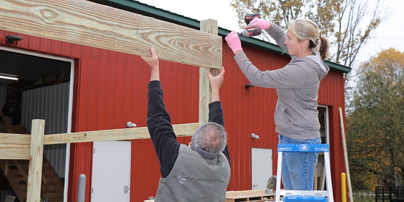 Volunteers building wood frame structure